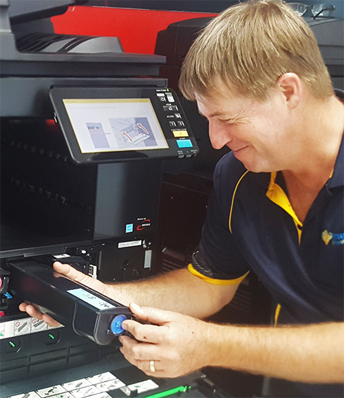Service technician replacing a toner cartridge